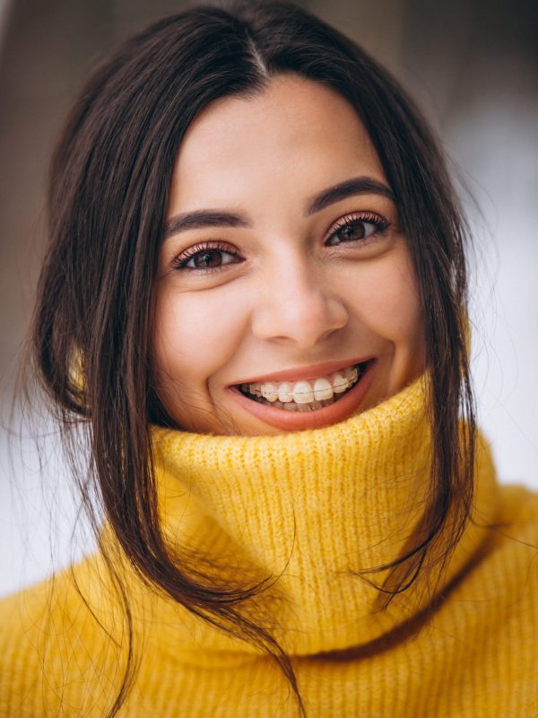 Portrait of a young girl in a yellow sweater